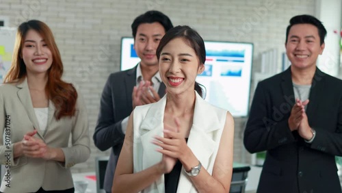 group of Asian men and women business teams applauded their business successes to their office friends