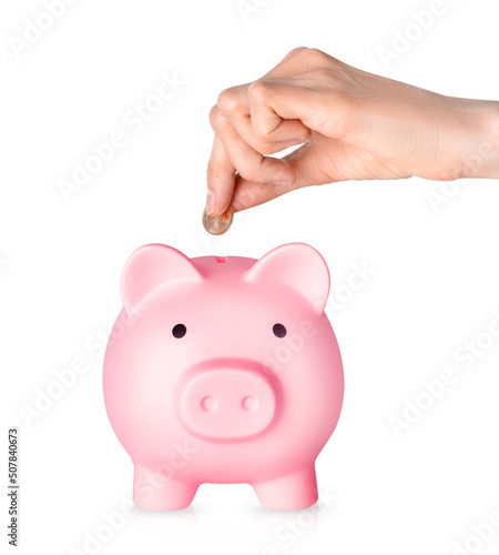 Human hand putting coins in piggy bank isolated on white background. Money saving concept