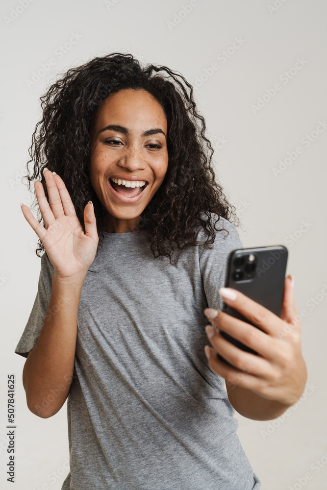 Young black woman using cellphone and making gesturing Young black woman using cellphone and making gesturing