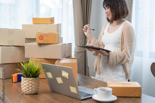 Asian women counting boxes before shipping to customers, work from home, small business owners or small business entrepreneurs just starting out working on online marketing shipping boxes.