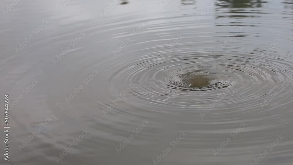 Water flows down the main hole. The flood water drained into the pipes on the side of the road and reflected the traffic of cars on the water surface. Water flows down the main hole. The flood water drained into the pipes on the side of the road and reflected the traffic of cars on the water surface.