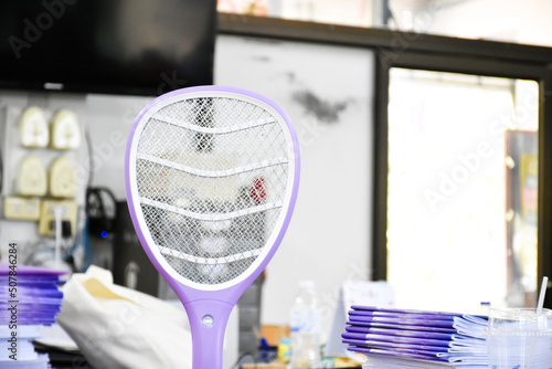 Electronic mosquito swatter in the office room for killing mosquitoes and insects inside the office, soft and selective focus.