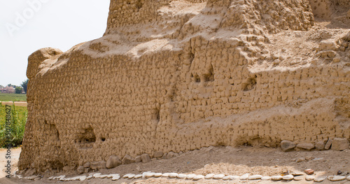 Ancient Adobe brick wall of structure in ruins in cerro de oro - Lima, Peru photo