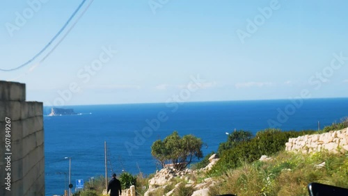 Driving POV towards majestic blue Meditarreanean sea downhill in Malta photo