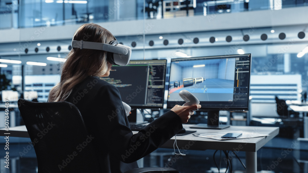 Automotive Engineer Using a VR Software to Work on Electric Motor and Vehicle Platform in Interactive Environment in a Factory Office. Industrial Engineer Using Headset and Controllers.