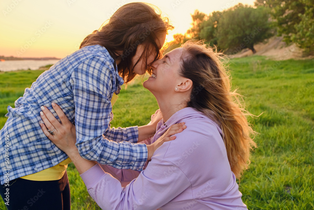 happy family mother and child daughter in nature Park in summer on green grass happy family mother and child daughter in nature Park in summer on green grass
