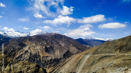 Amazing snow covered mountains with high Spiti valley, blue sky with clouds in India. Mountain valley. Travel in Himachal Pradesh. Nature