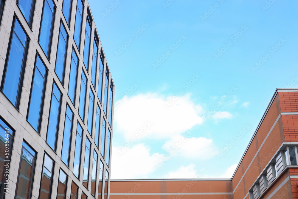 Modern buildings against blue sky, low angle view. space for text Modern buildings against blue sky, low angle view. space for text