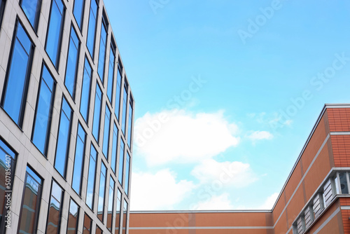 Modern buildings against blue sky, low angle view. space for text