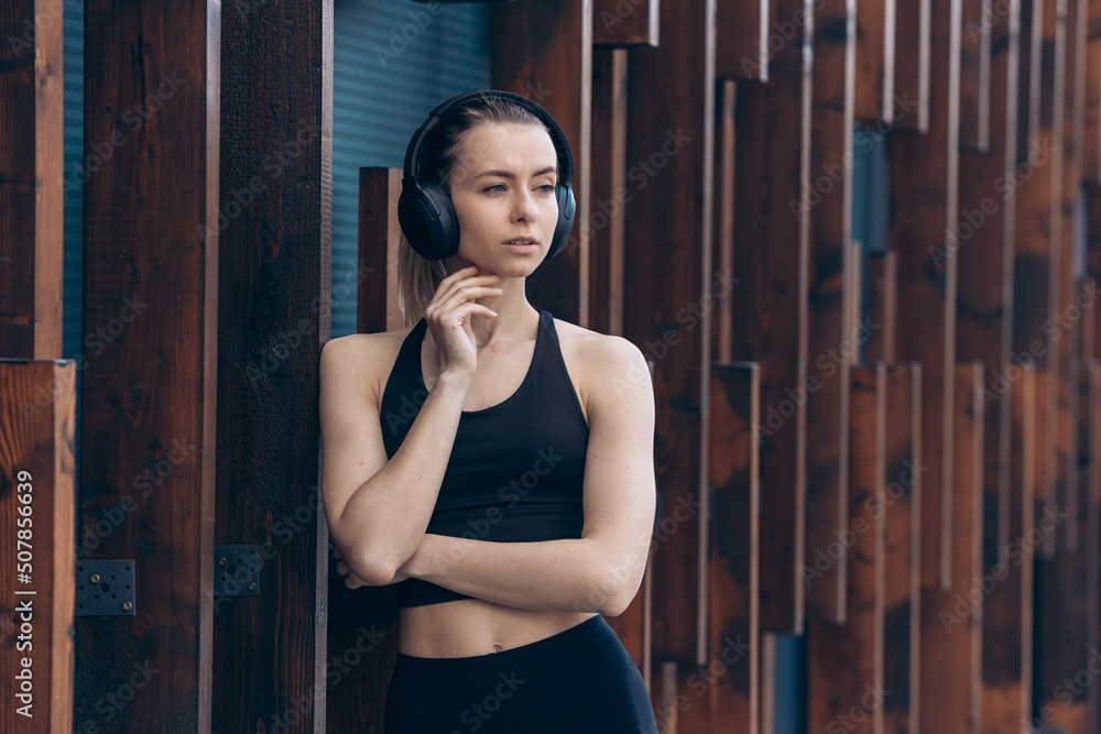 Fototapeta premium Pretty girl leaning on wall, conceived.