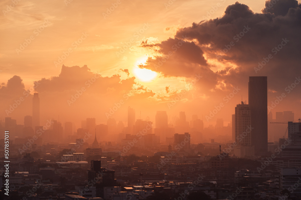 Sunrise over high rise building in business district at Bangkok city