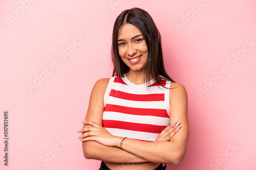 Young hispanic woman isolated on pink background happy, smiling and cheerful.