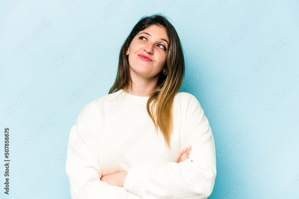 Young caucasian woman isolated on blue background dreaming of achieving goals and purposes Young caucasian woman isolated on blue background dreaming of achieving goals and purposes