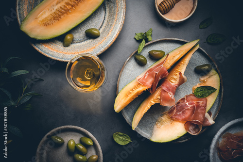 Jamon serrano, ham or prosciutto with melon and olives, a traditional Spanish an Fototapet