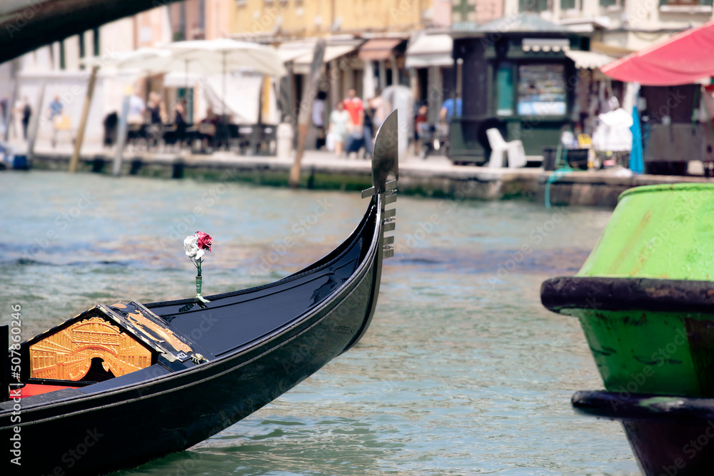 View on Venice city life with detail of gondola close-up by the canal, summer Italy.