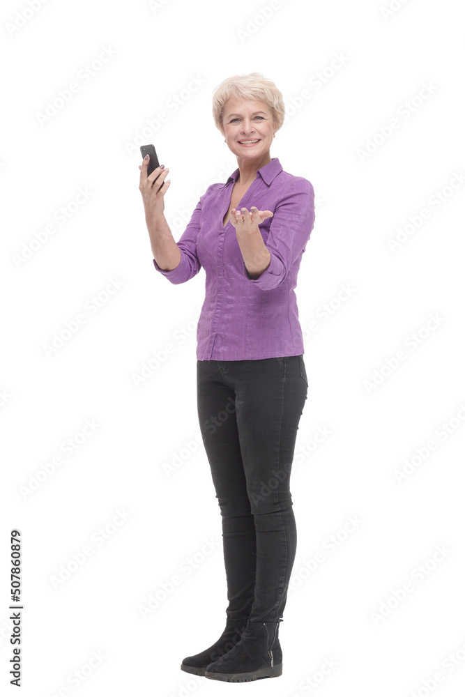 in full growth. smiling mature woman with a smartphone . in full growth. smiling mature woman with a smartphone .