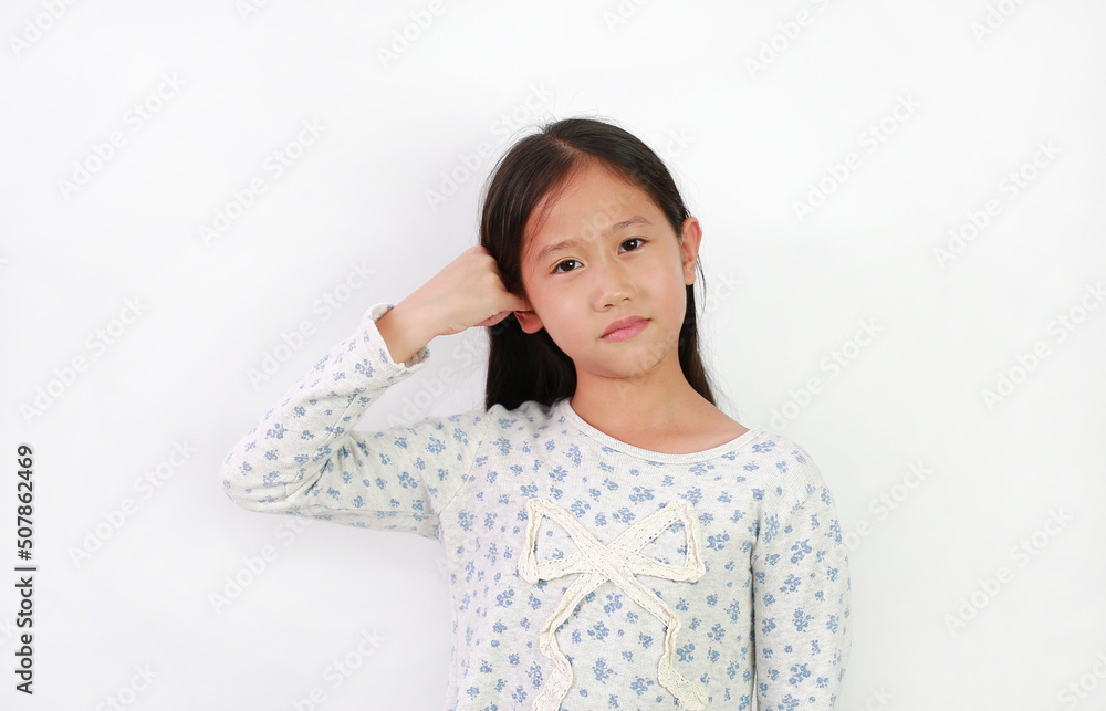 Asian girl child covers one ear with little finger not to hear and looks at camera isolated on white background. Asian girl child covers one ear with little finger not to hear and looks at camera isolated on white background.
