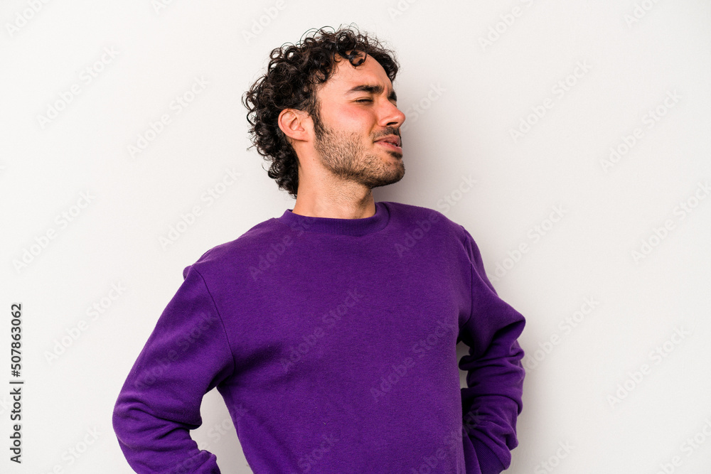 Young caucasian man isolated on white background suffering a back pain. Young caucasian man isolated on white background suffering a back pain.