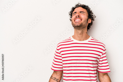 Young caucasian man isolated on white background shouting very angry, rage concept, frustrated.