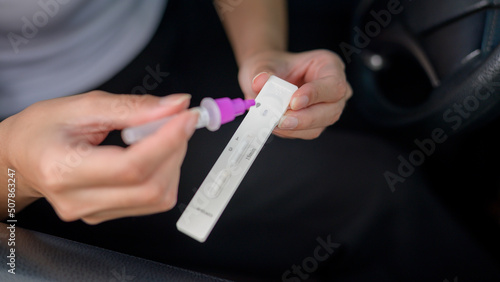 A woman do a self-collection test for a COVID-19 test, health and safety © tonefotografia