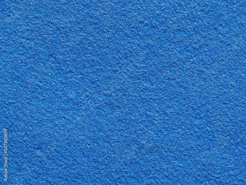 Bright blue rough textured background. Close-up of the texture of fleecy fabric. Blue Synthetic fiber surface