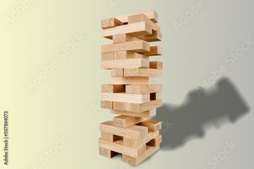 Jenga wooden tower made of wooden blocks on the desk
