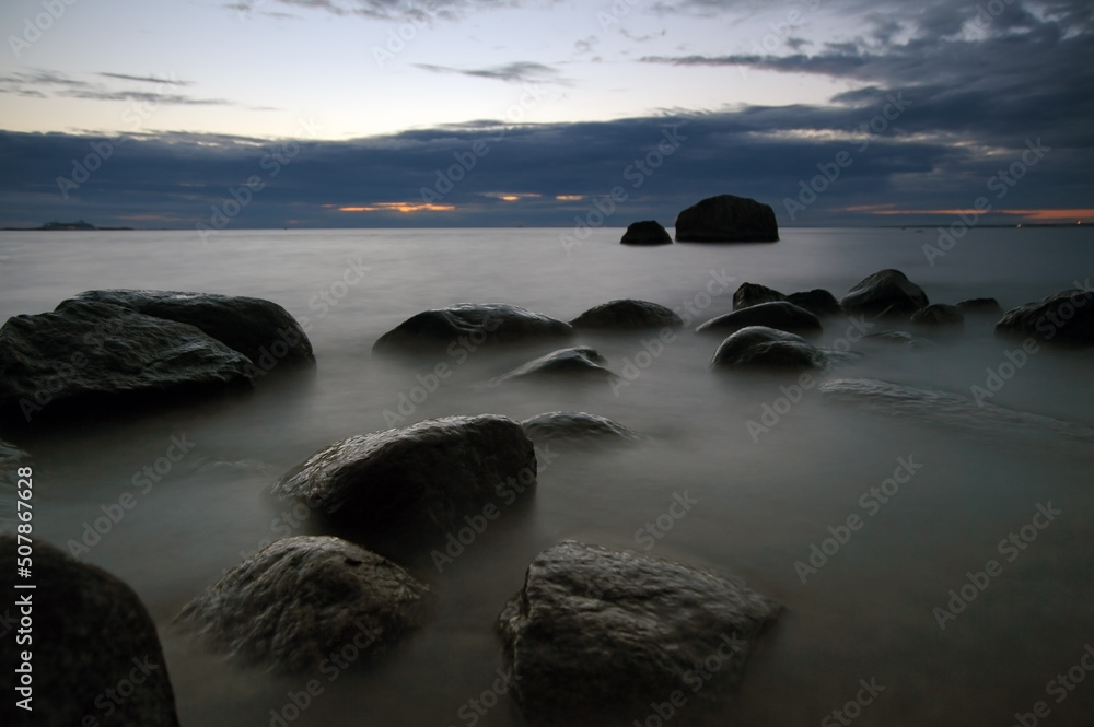 Long exposure sea with stones in water at night