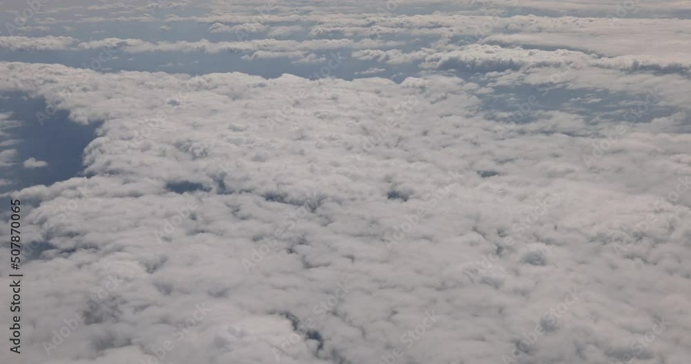 White fluffy clouds in altitude during flying above the sky of aircraft White fluffy clouds in altitude during flying above the sky of aircraft