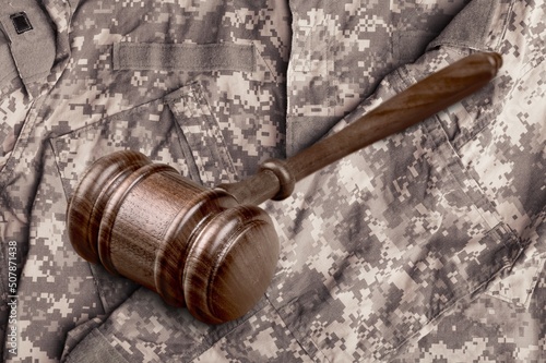 Military Law concept, soldier and wooden gavel at courtroom.