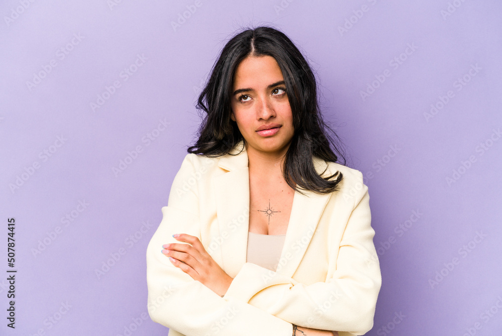 Young hispanic woman isolated on purple background tired of a repetitive task. Young hispanic woman isolated on purple background tired of a repetitive task.
