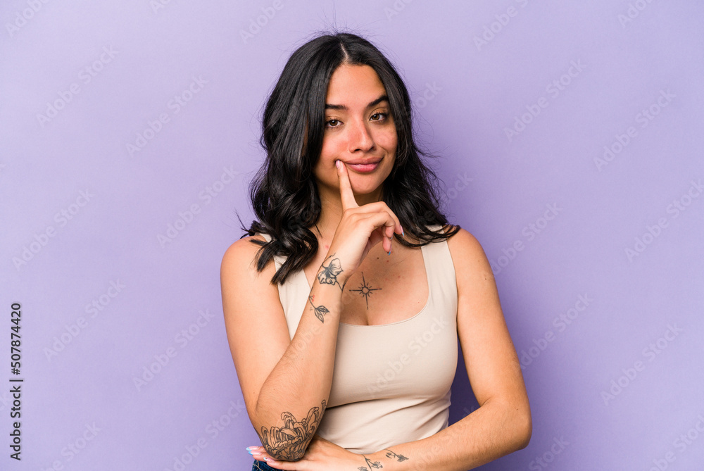 Young hispanic woman isolated on purple background contemplating, planning a strategy, thinking about the way of a business. Young hispanic woman isolated on purple background contemplating, planning a strategy, thinking about the way of a business.