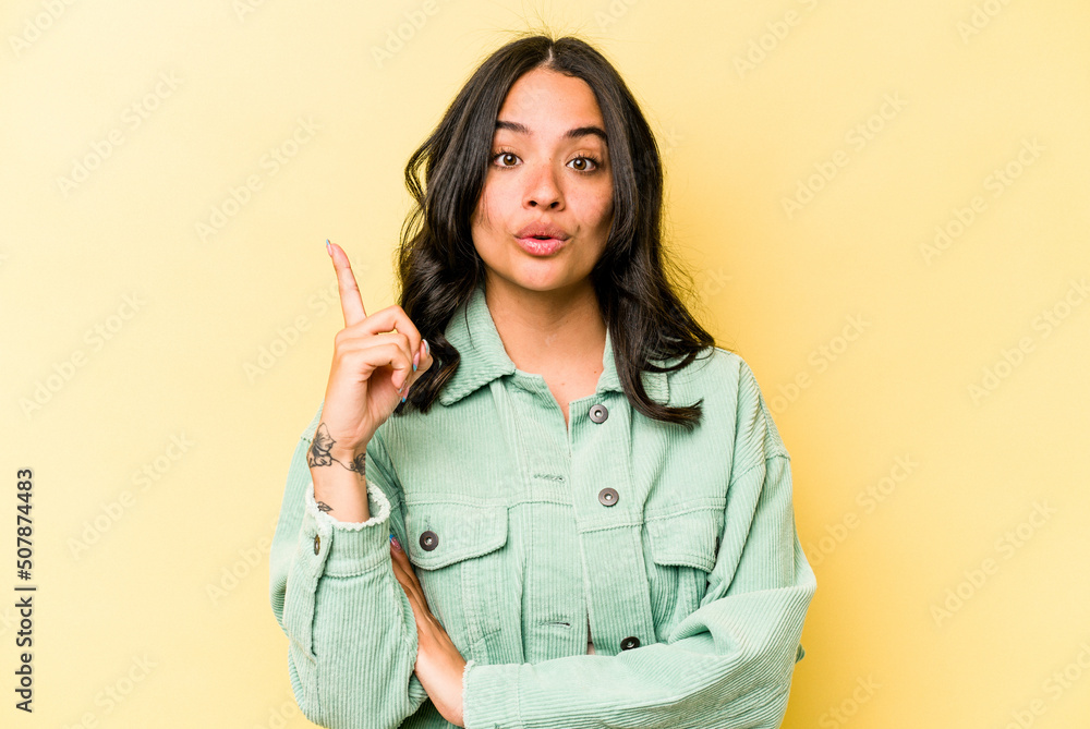 Young hispanic woman isolated on yellow background having some great idea, concept of creativity. Young hispanic woman isolated on yellow background having some great idea, concept of creativity.