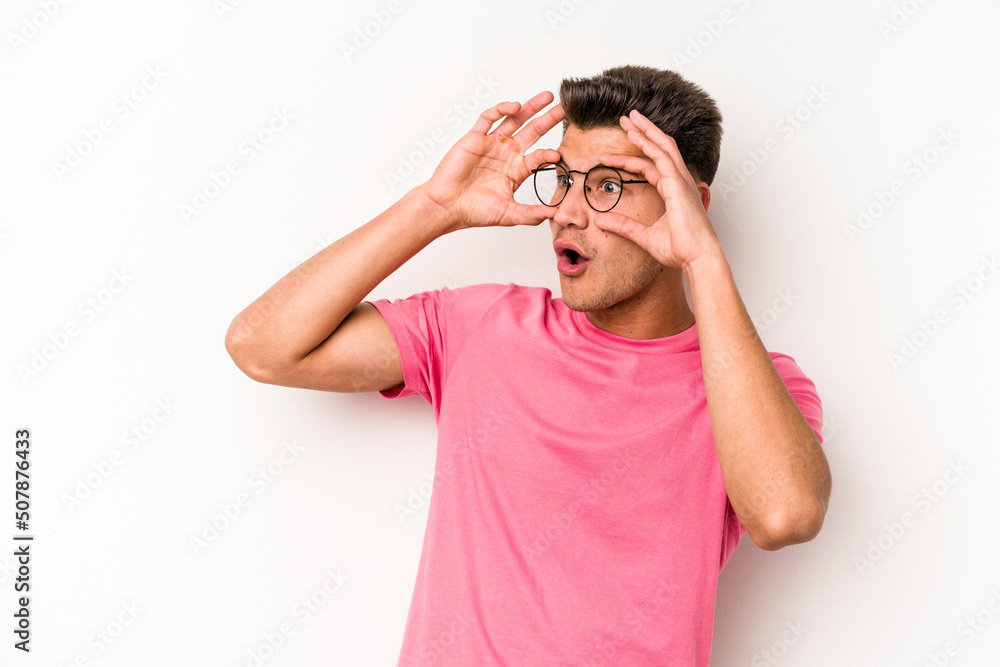 Young caucasian man isolated on white background keeping eyes opened to find a success opportunity. Young caucasian man isolated on white background keeping eyes opened to find a success opportunity.