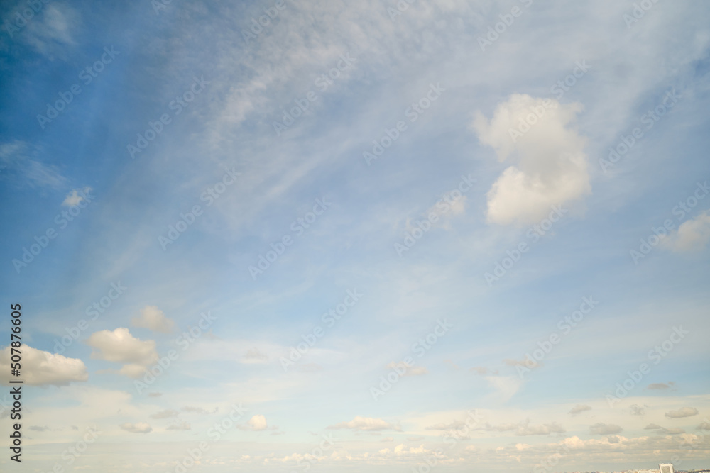 White cumulus clouds in the blue sky. Bright beautiful sky, copy space background White cumulus clouds in the blue sky. Bright beautiful sky, copy space background