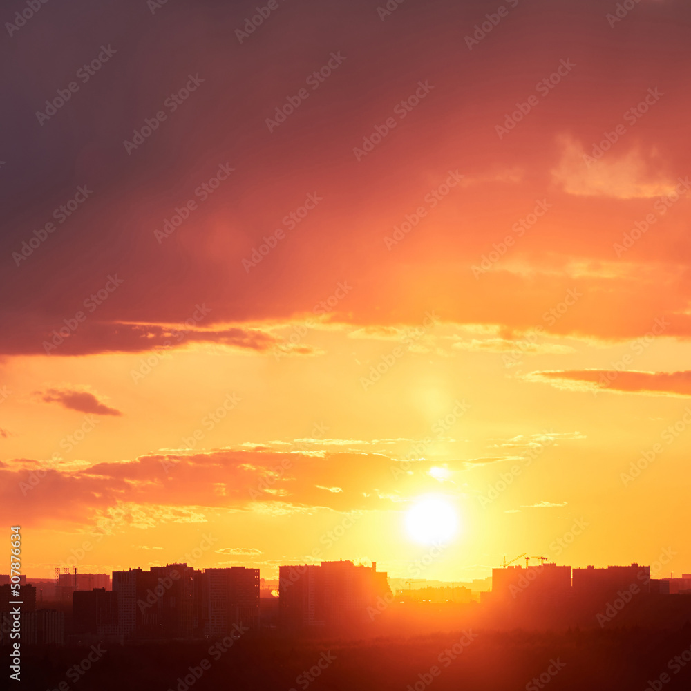 Dark clouds in the evening sunset sky with the setting sun. Dramatic sky during orange sunset Dark clouds in the evening sunset sky with the setting sun. Dramatic sky during orange sunset