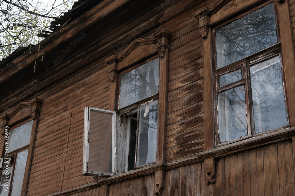 THE WINDOW OF AN OLD ABANDONED WOODEN HOUSE THE WINDOW OF AN OLD ABANDONED WOODEN HOUSE