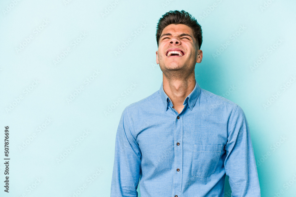 Young caucasian man isolated on blue background shouting very angry, rage concept, frustrated. Young caucasian man isolated on blue background shouting very angry, rage concept, frustrated.