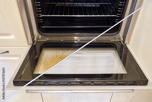 Fotografie Dirty and clean oven, before and after cleaning and washing the stove glass