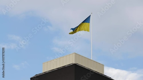 Ukrainian national flag is unfolding in the wind with the sky background