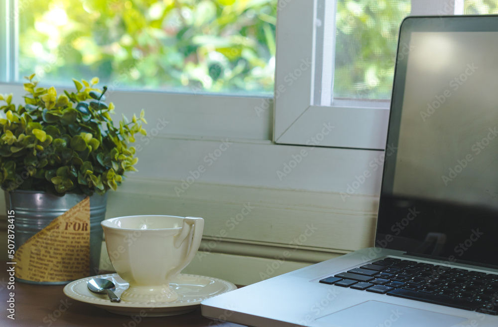 Computer and coffee cup on desk and plant pots.business nature concept. Computer and coffee cup on desk and plant pots.business nature concept.