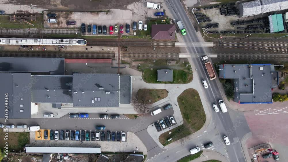 Aerial view of railway station in small town and passenger train arriving, Transport infrastructure, Regional public transport Aerial view of railway station in small town and passenger train arriving, Transport infrastructure, Regional public transport