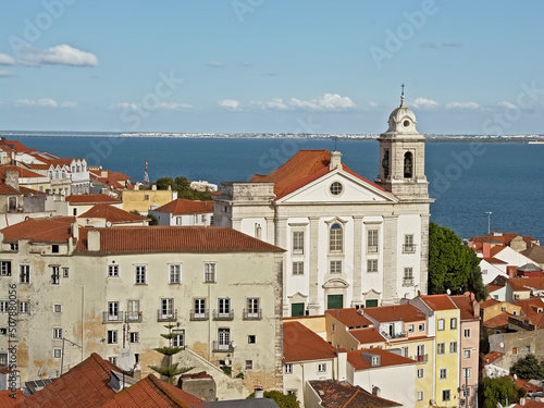 Graca church and traditional houses in front of Tagus river in Lisbon, portugal photo