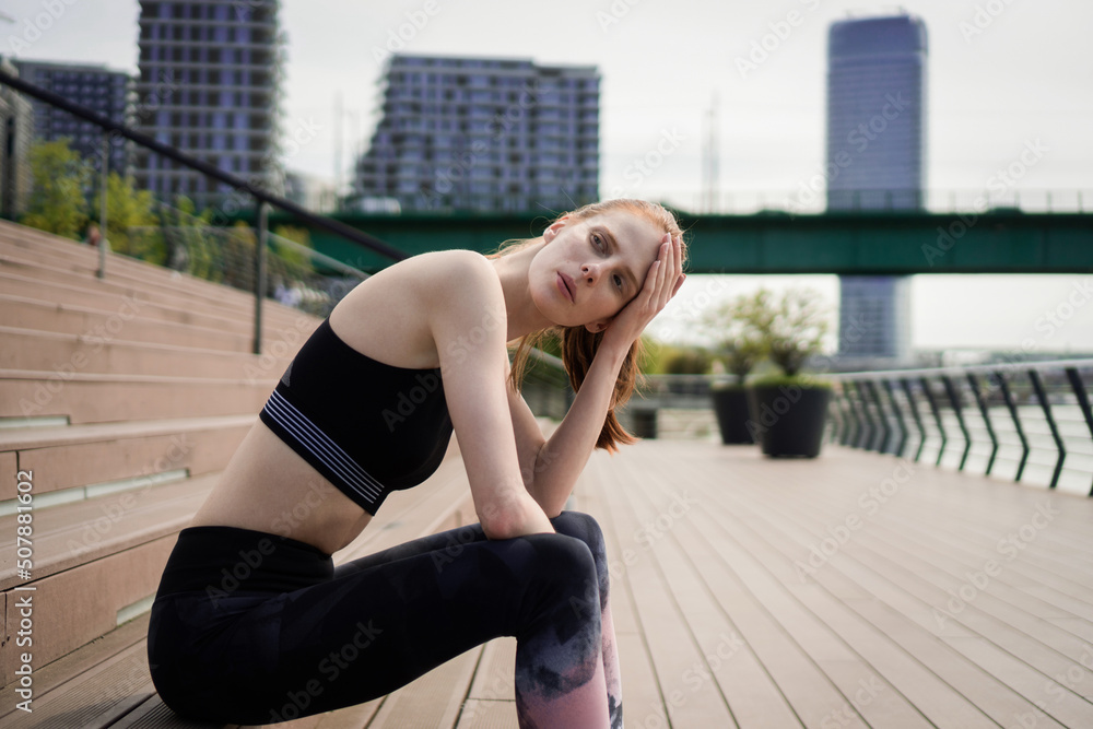 Athlete woman taking a break from sports training outdoors Athlete woman taking a break from sports training outdoors