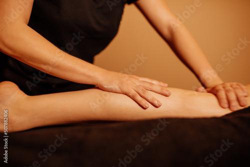 unrecognizable person doing a leg massage in a health and wellness center. beauty and health concept