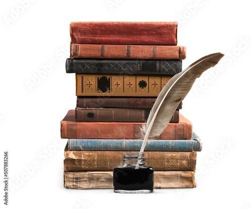 Stack of old antique books, inkwell with quill pen.