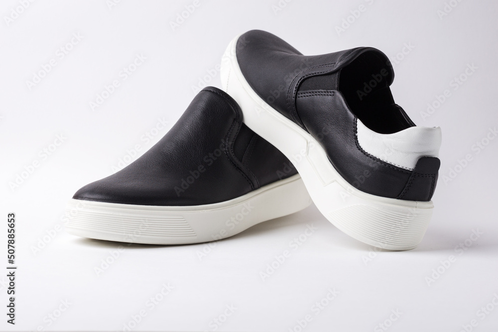 Black leather slip-ons shoes on white background. Black leather slip-ons shoes on white background.