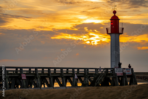 Photos Lighthouse at the entrance to the harbor on the coast of Normandy in France