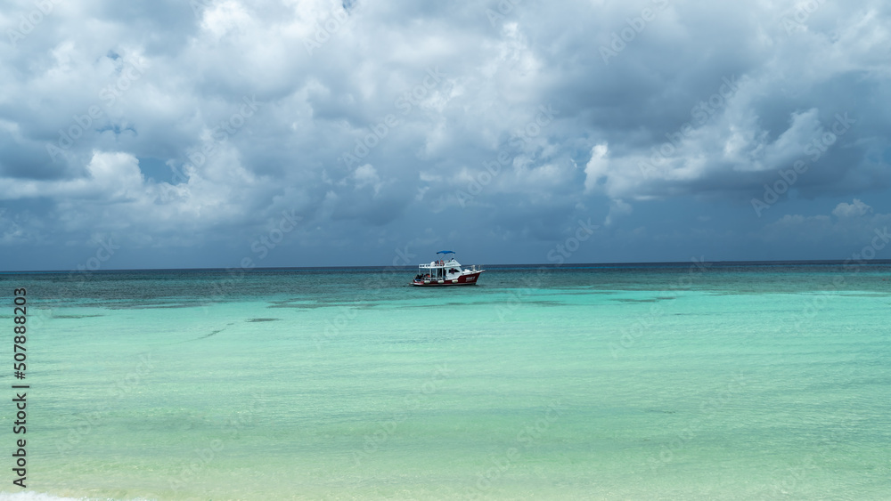 beautiful horizontal sea landscape in cozumel island - boat in the water