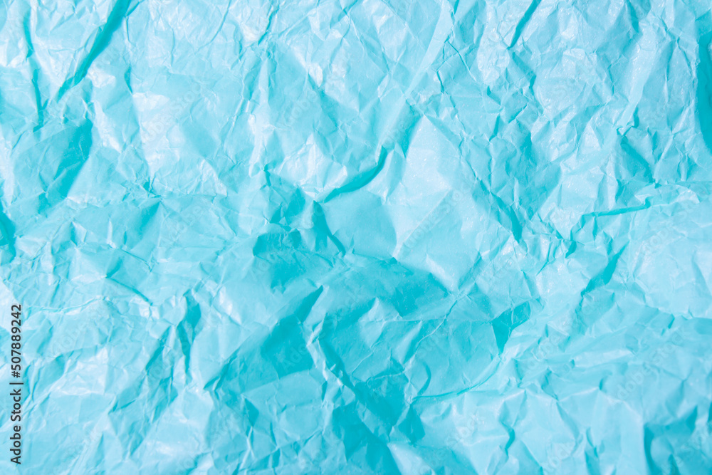 Abstract bright blue background. Squeezed multicolored craft paper Abstract bright blue background. Squeezed multicolored craft paper