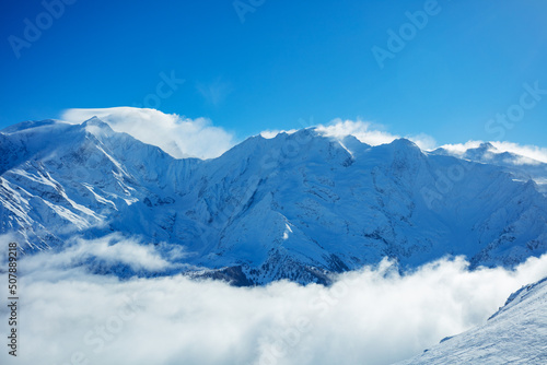 View above clouds of Alps mountains and Mont Blanc massif © Sergey Novikov